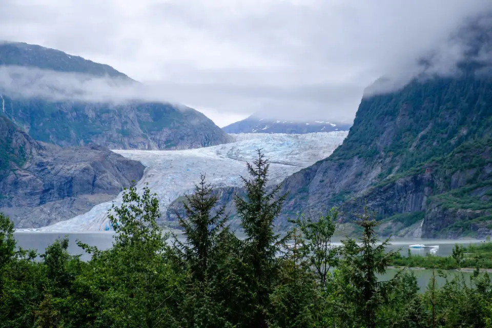 Mendenhall Glacier flowing between forested mountains near Juneau, Alaska