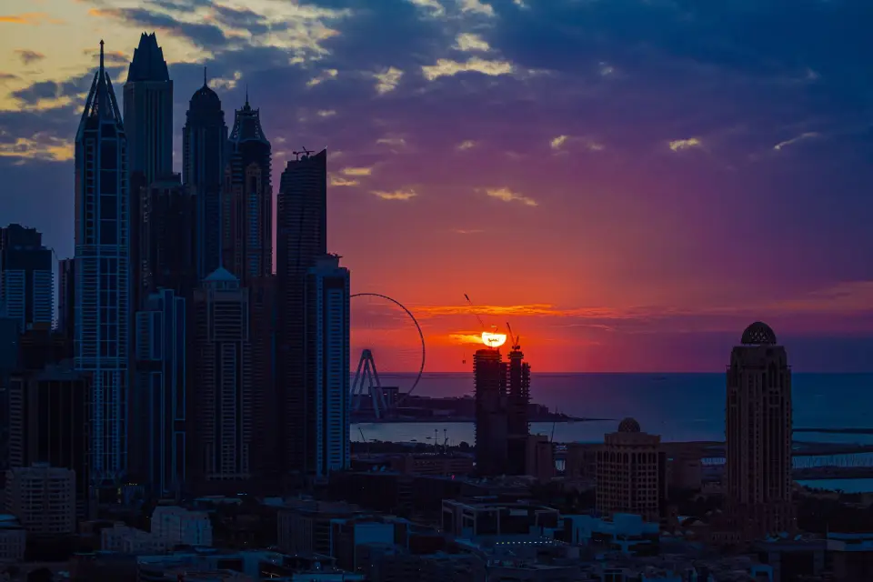 Dubai Marina towers silhouetted against a violet sunset