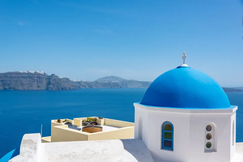 A blue-domed chapel overlooking the Santorini caldera
