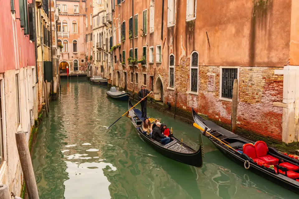 A gondola gliding along a quiet canal in Venice