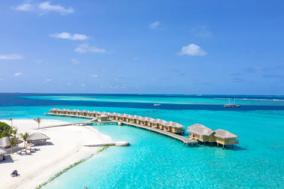 White-sand beach and overwater bungalows on a Maldives island