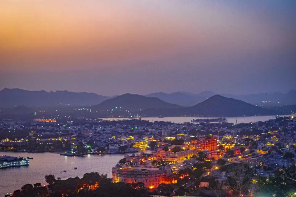 Udaipur and its lakes glowing at dusk below the Aravalli hills