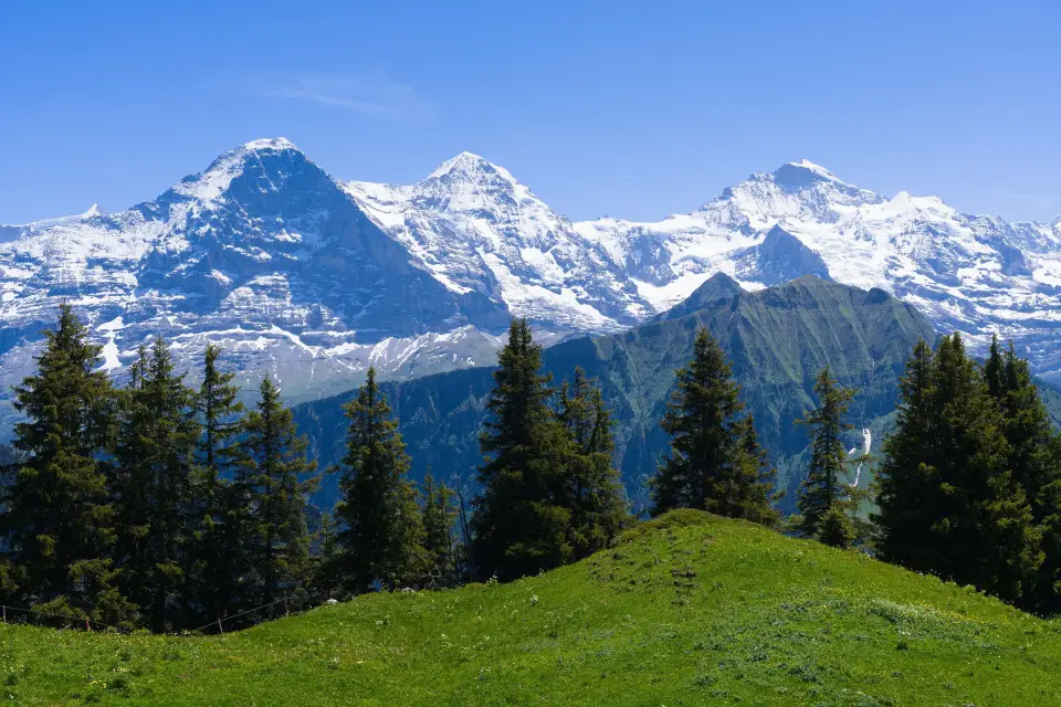 The Eiger, Mönch and Jungfrau above alpine meadows, Bernese Oberland